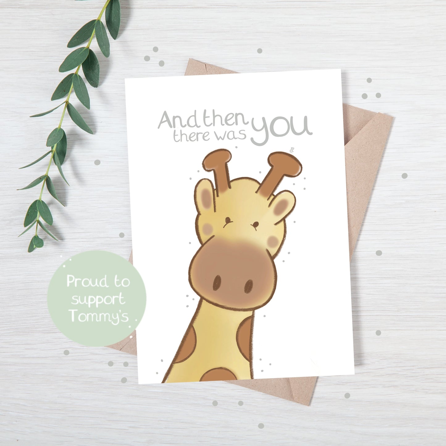 Handmade luxury new baby christening greetings card with a safari theme baby giraffe popping up from the bottom with the title "e "and then there was you" on a white background, with a kraft envelope