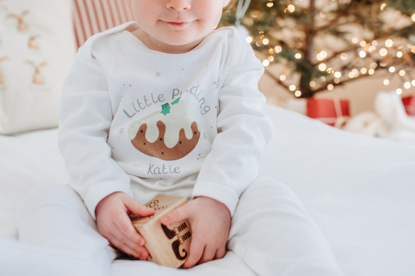 close up of little pudding babygrow design
