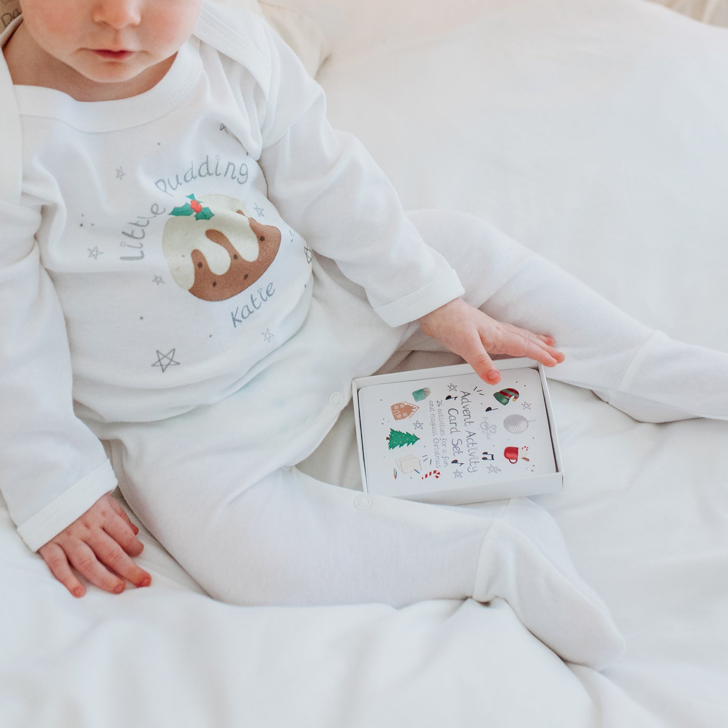 baby sat up with advent activity card set wearing a little pudding outfit