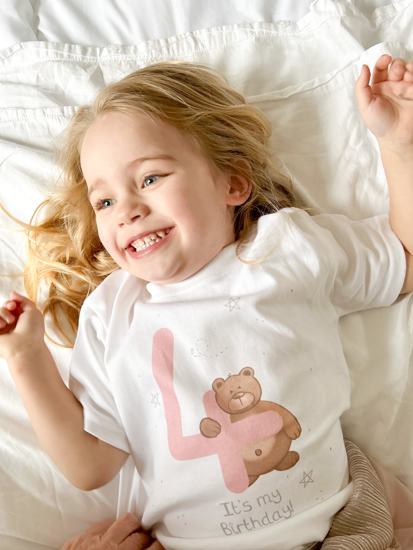 girl giggling wearing 4th birthday t-shirt with a pink number 4 and woodland brown bear and it's my birthday design