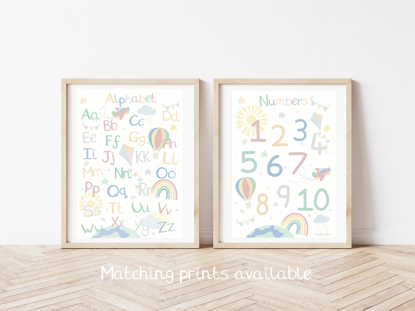 set of two matching nursery prints of letters of the alphabet and numbers 1-10 in bright colours with rainbows, balloons and sunshine designs