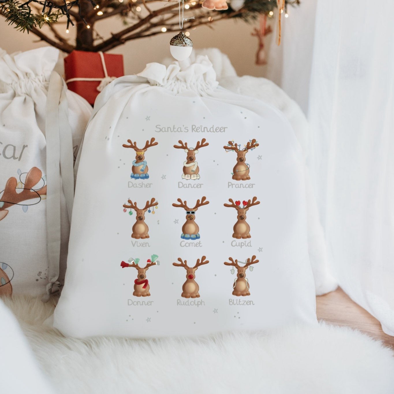 christmas sack under a tree with santa's reindeer design printed on it
