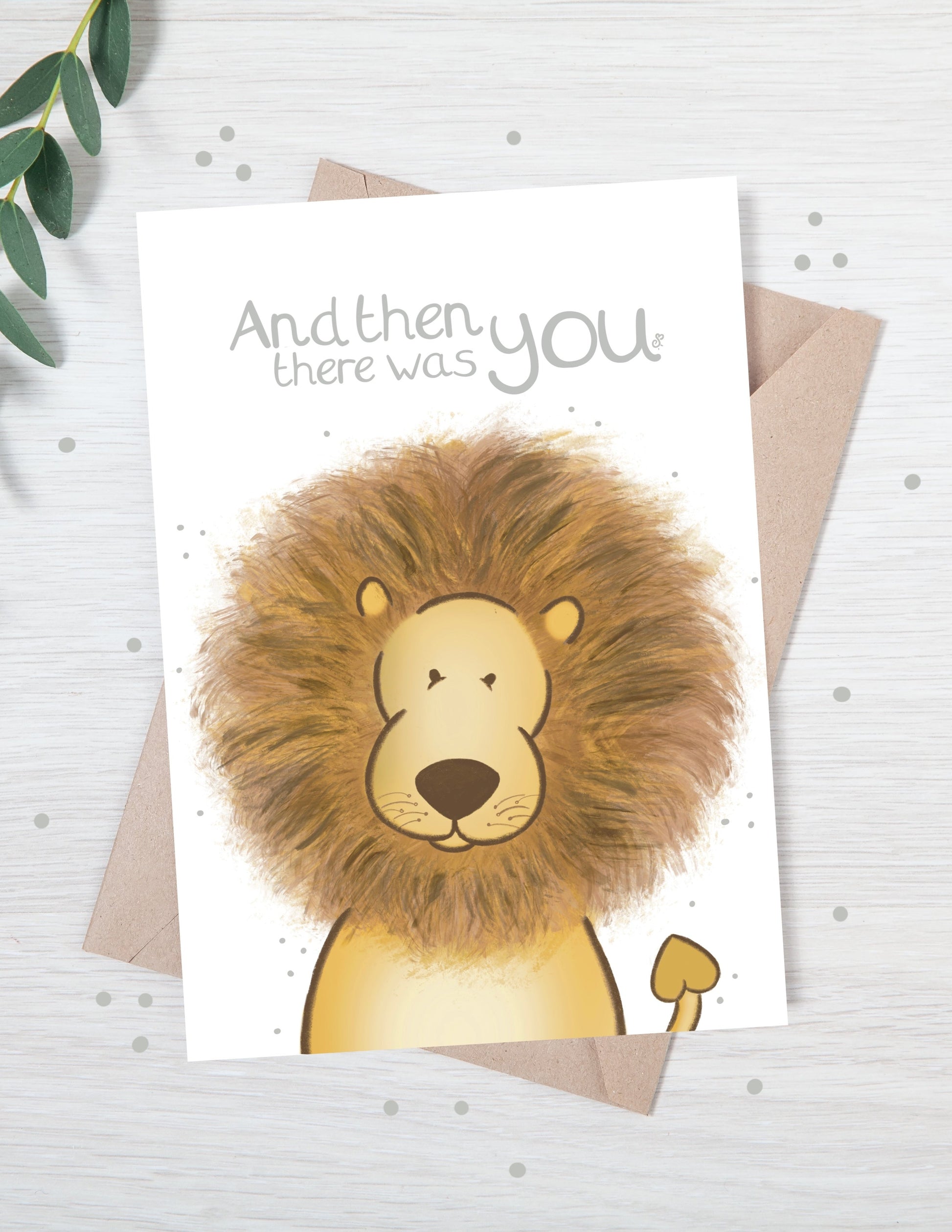 Handmade luxury baby shower greetings card with a safari theme baby lion popping up from the bottom with the title &quote "and then there was you" on a white background, with a kraft envelope