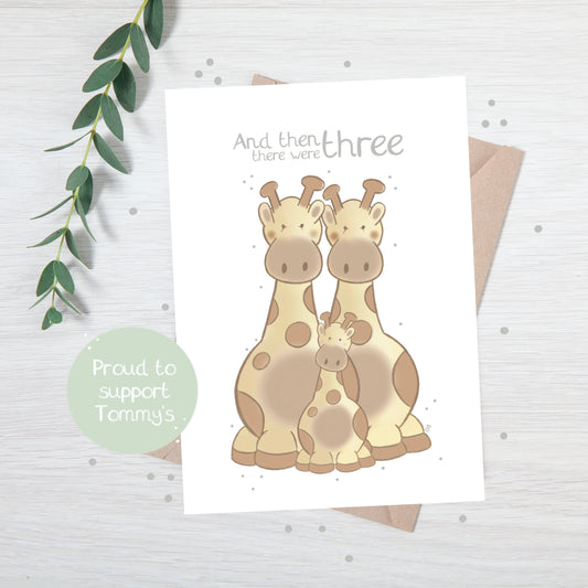 Handmade luxury new baby greetings card with a safari theme with a family of giraffes title &quote "and then there were 3" on a white background, with a kraft envelope