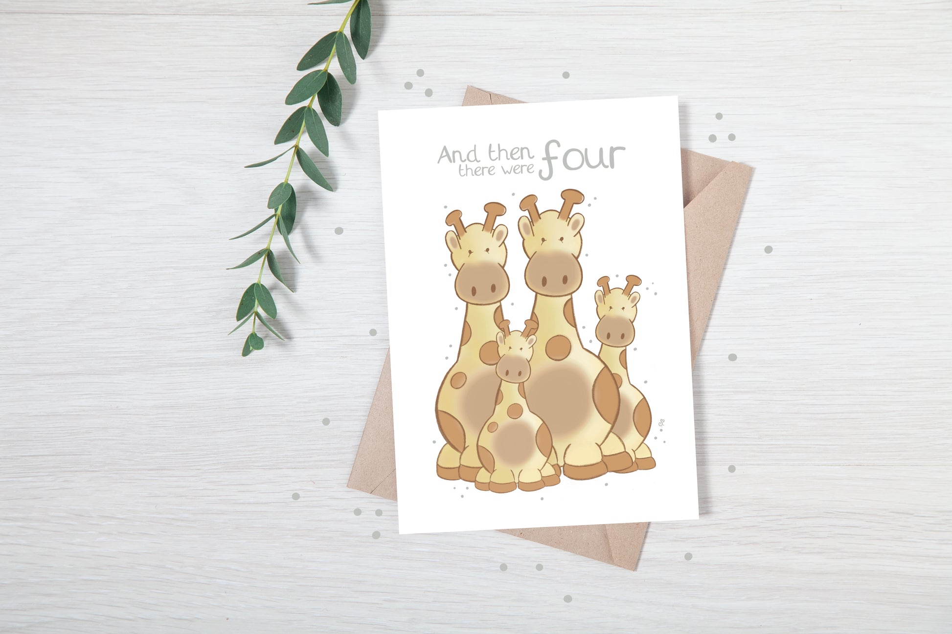 Handmade luxury new baby greetings card with a safari theme with a family of giraffes title &quote "and then there were 4" on a white background, with a kraft envelope