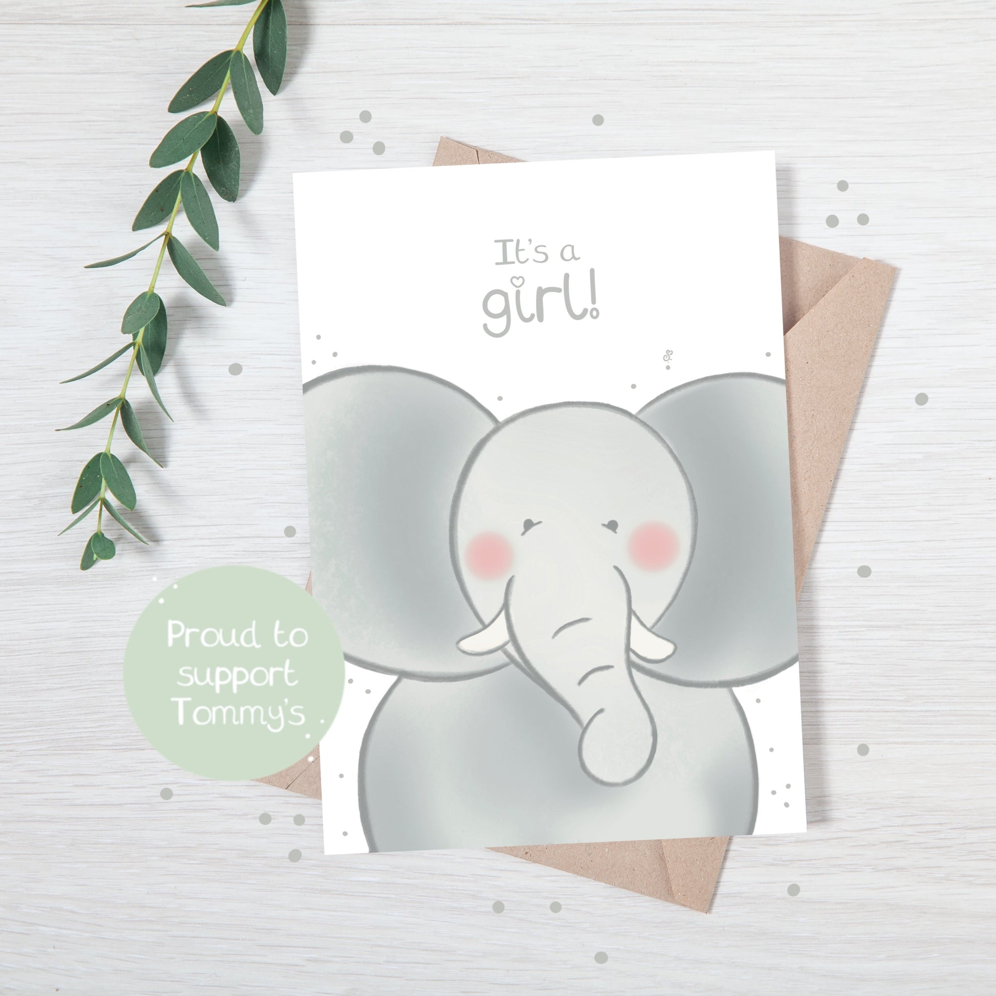 Handmade luxury new baby christening greetings card with a safari theme baby elephant popping up from the bottom with the title &quote "it's a girl" on a white background, with a kraft envelope