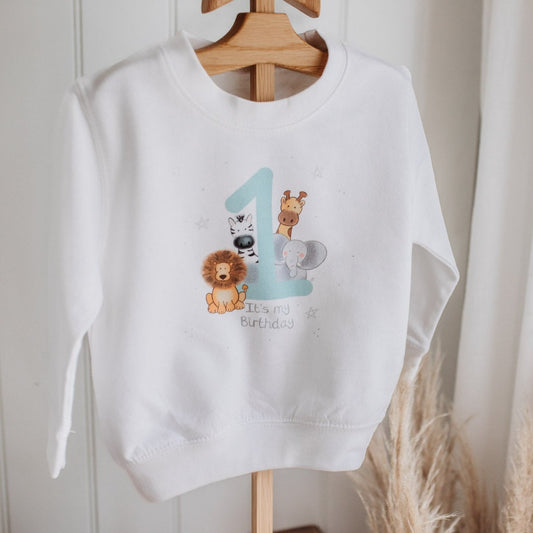 white children's birthday sweatshirt with safari animal 1st birthday design with lion, giraffe, zebra and elephant and neutral colours