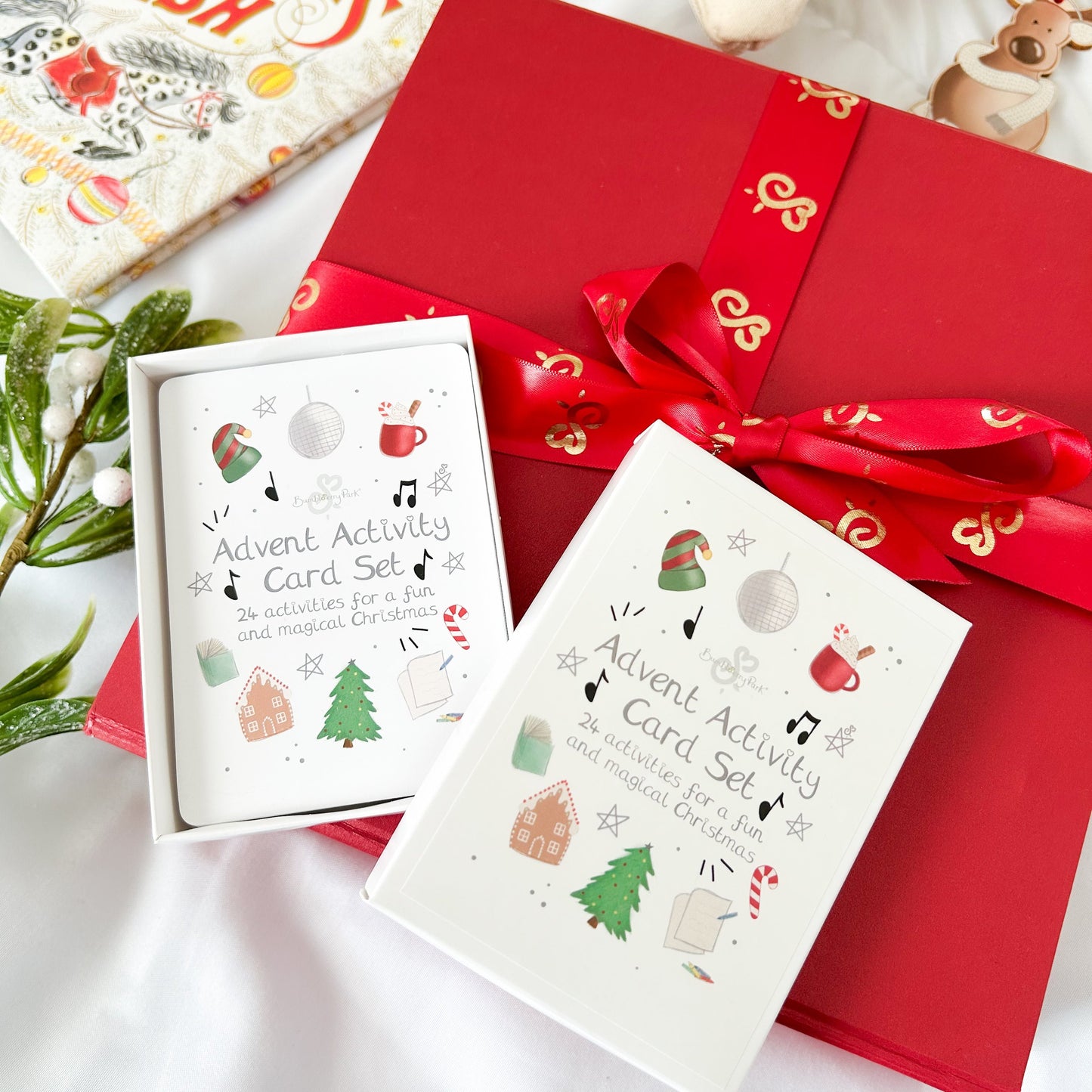 advent activity card set for children on top of a luxury red christmas gift box