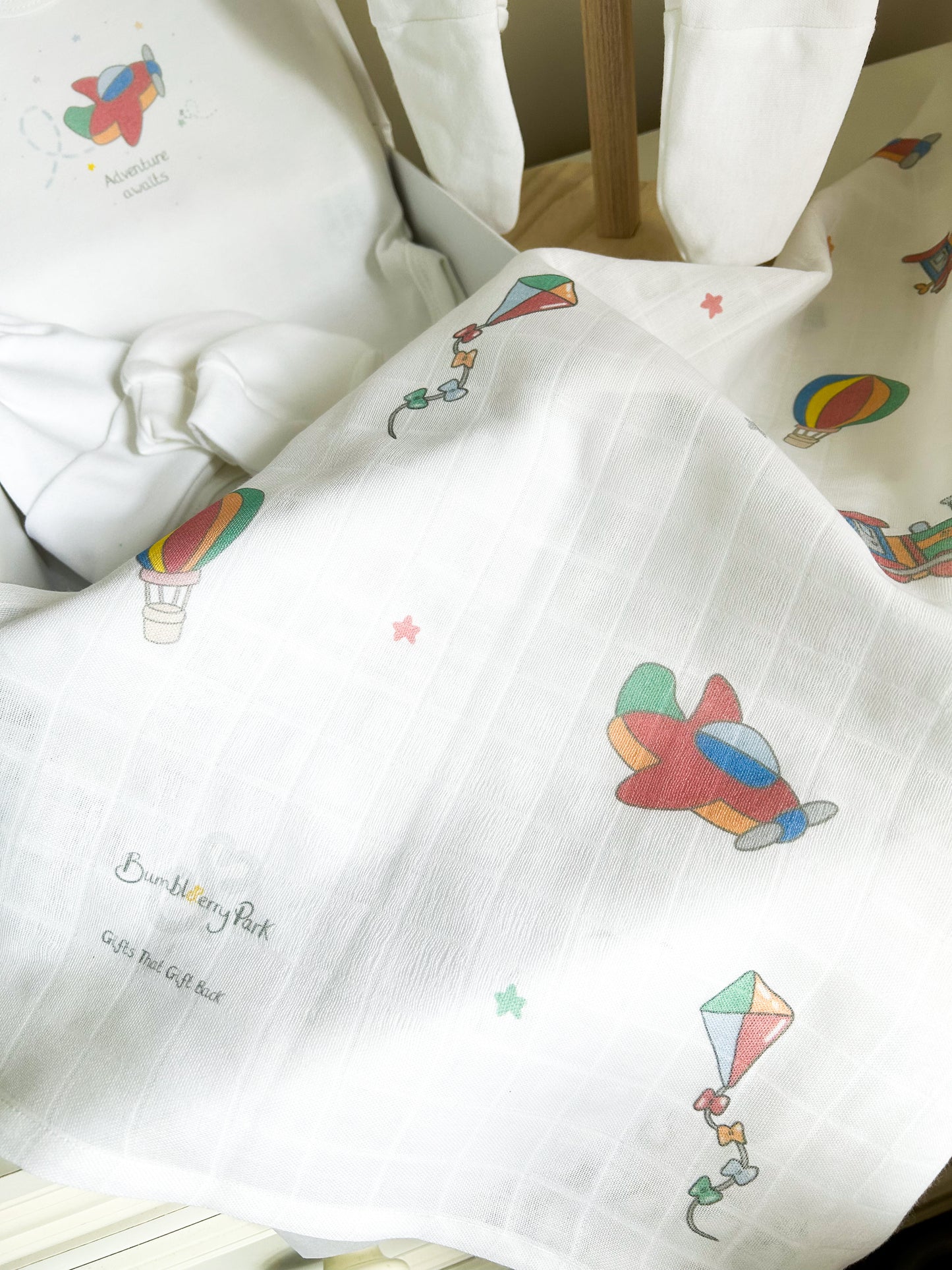 baby muslin square with a bright primary colours travel and transport little explorer design