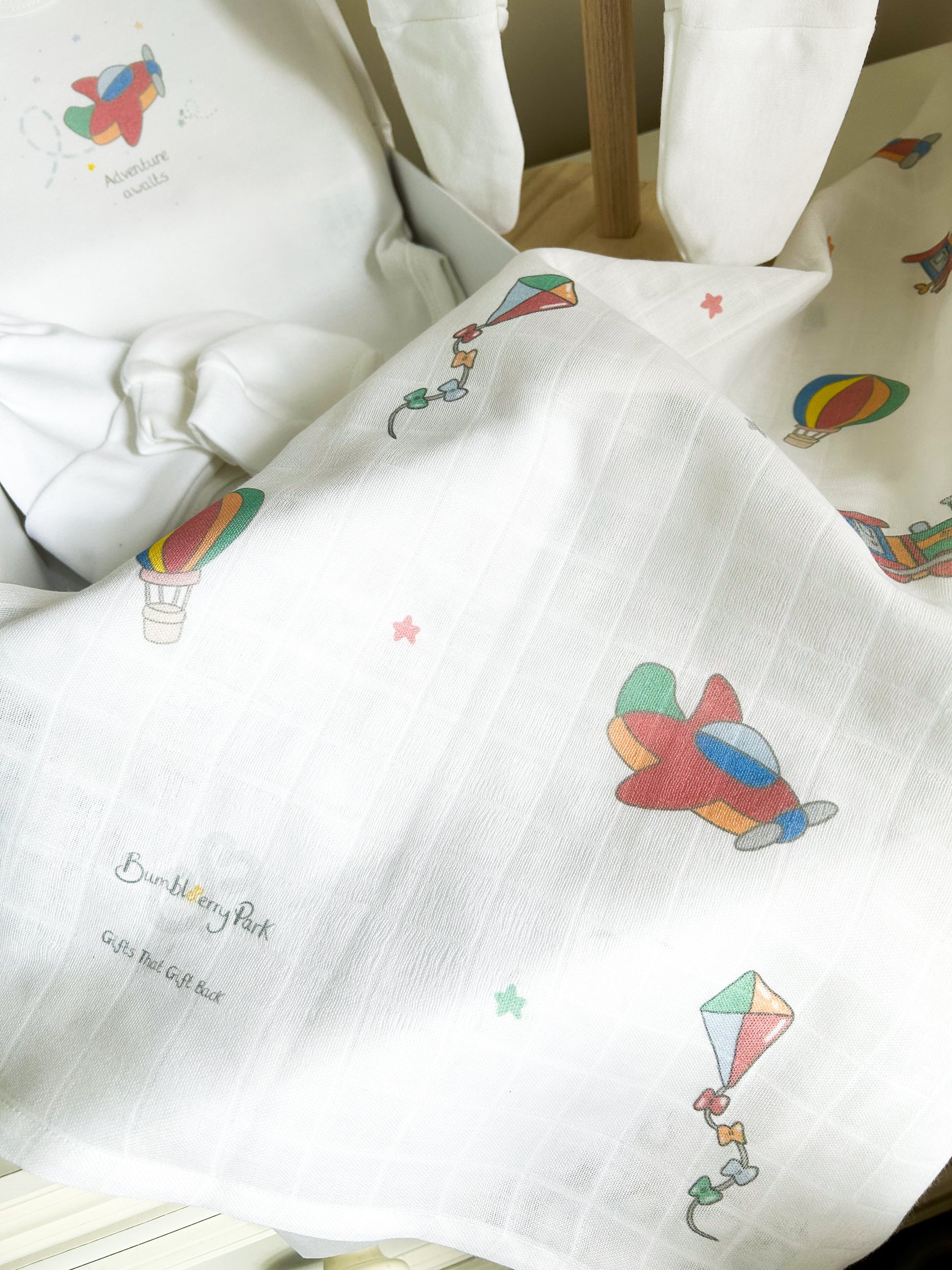 baby muslin square with a bright primary colours travel and transport little explorer design