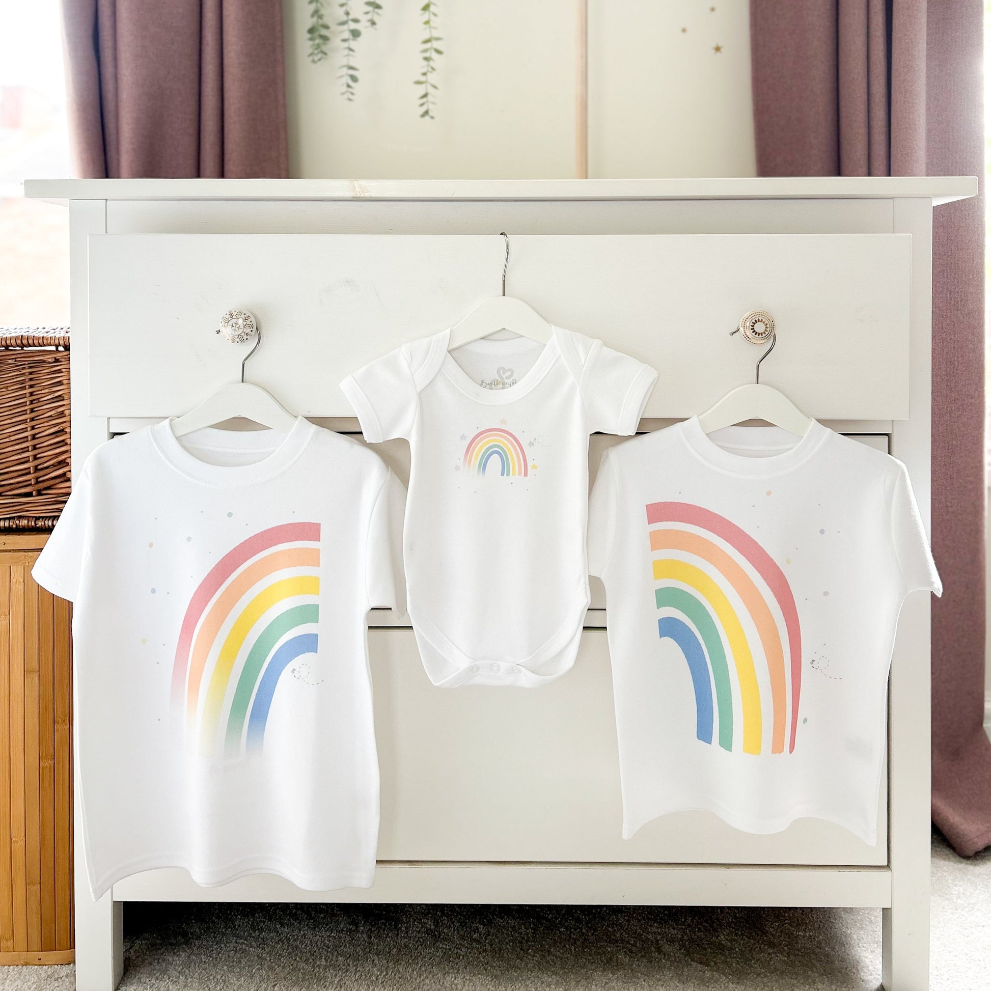 baby's nursery with a set of 2 matching rainbow t-shirts and babygrow for baby announcement
