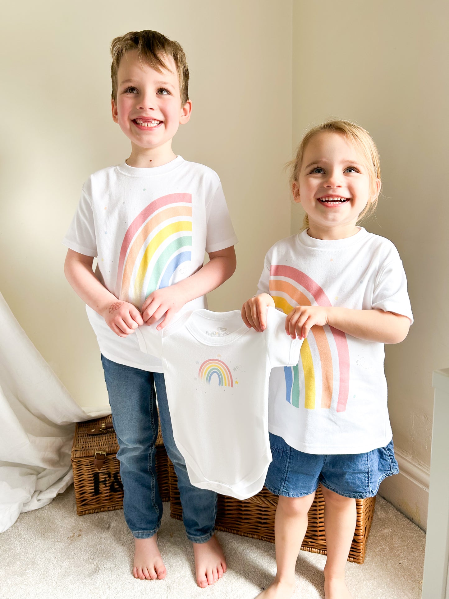 siblings holiday a baby vest for a pregnancy announcement with matching outfits with rainbow design