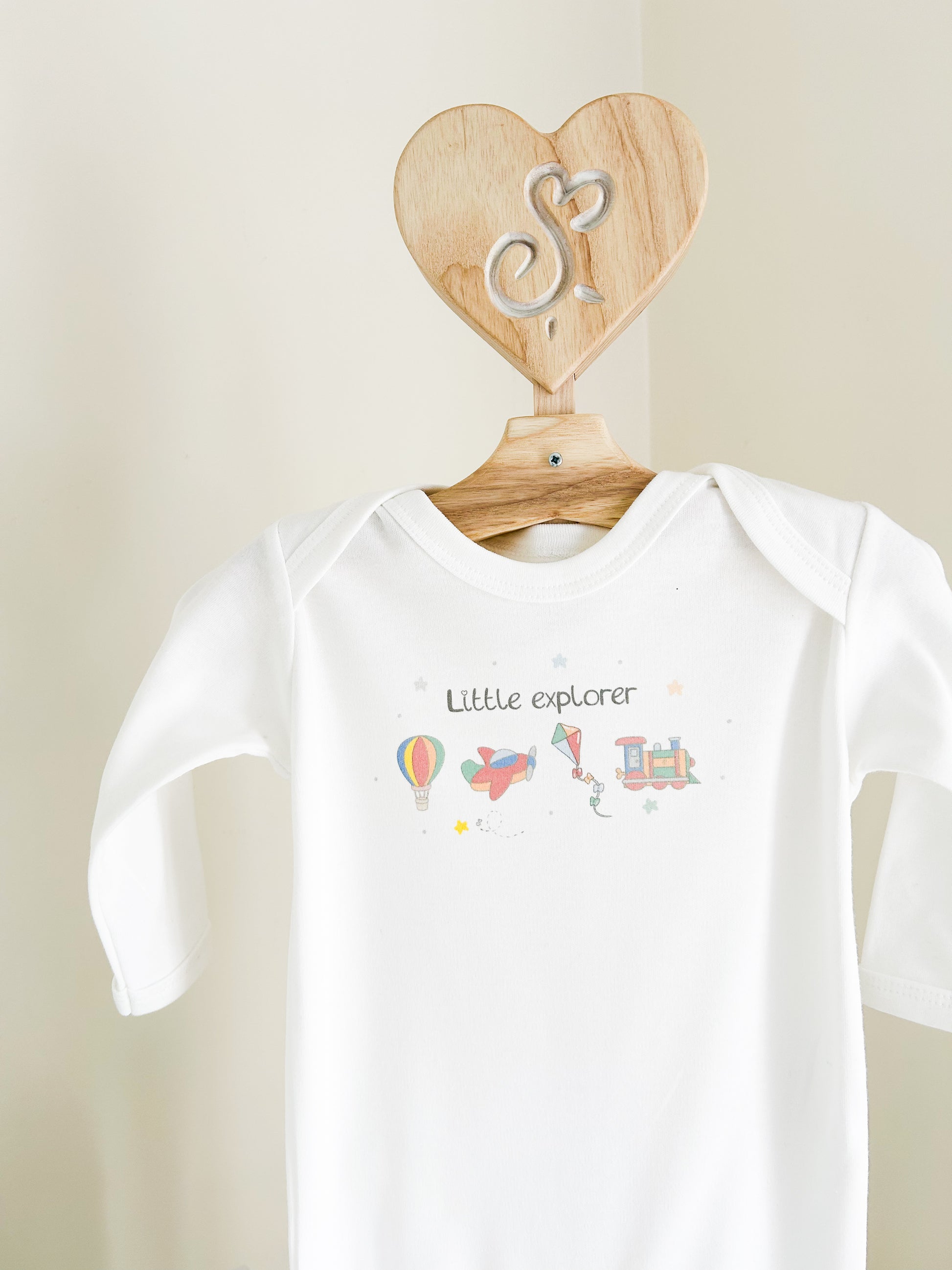 little explorers baby sleepsuit with a hot air balloon, aeroplane, kite and train design