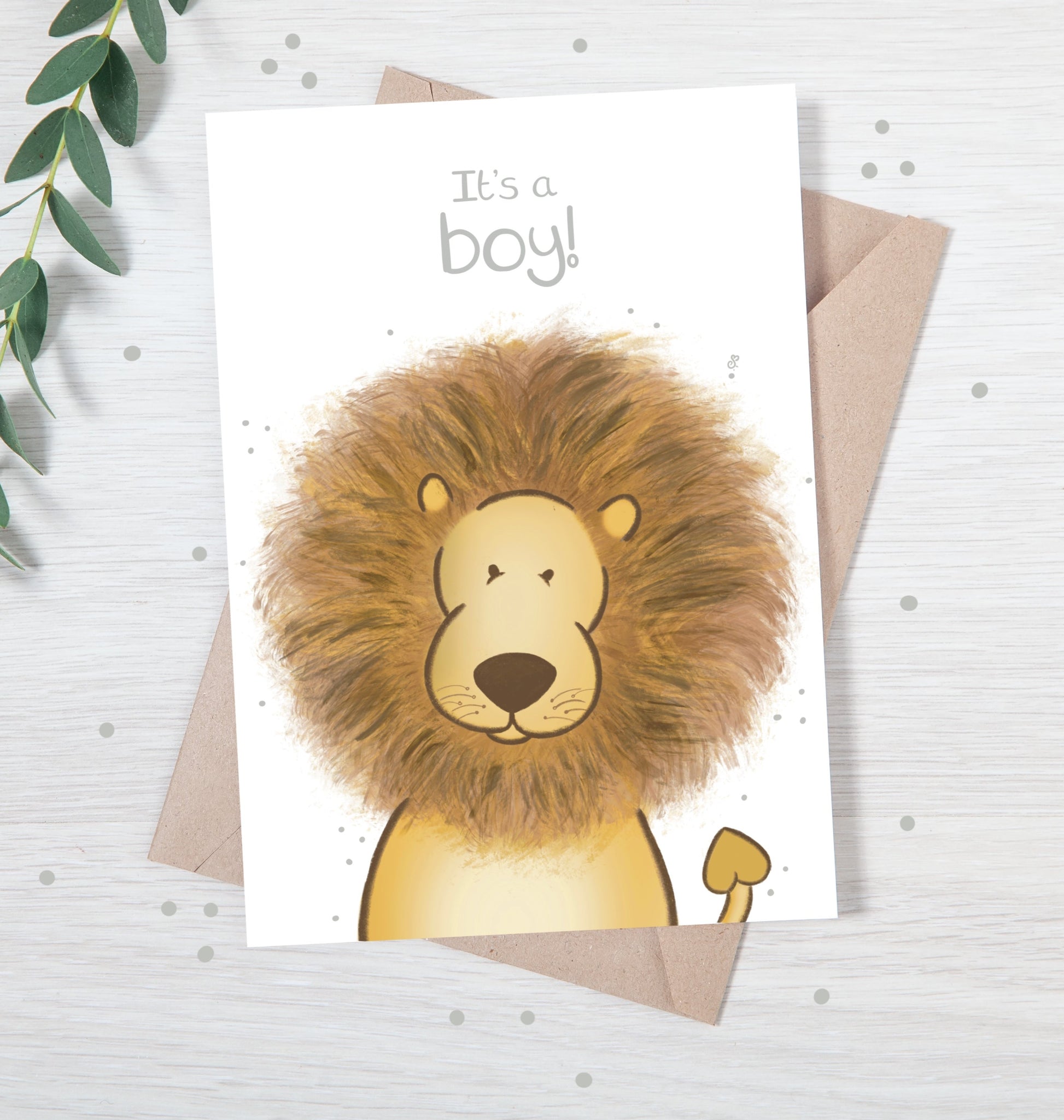 Handmade luxury new baby christening greetings card with a safari theme baby lion popping up from the bottom with the title &quote "it's a boy" on a white background, with a kraft envelope