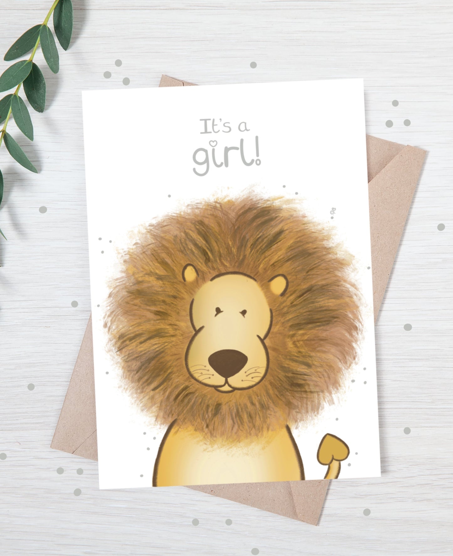 Handmade luxury new baby christening greetings card with a safari theme baby lion popping up from the bottom with the title &quote "it's a girl" on a white background, with a kraft envelope