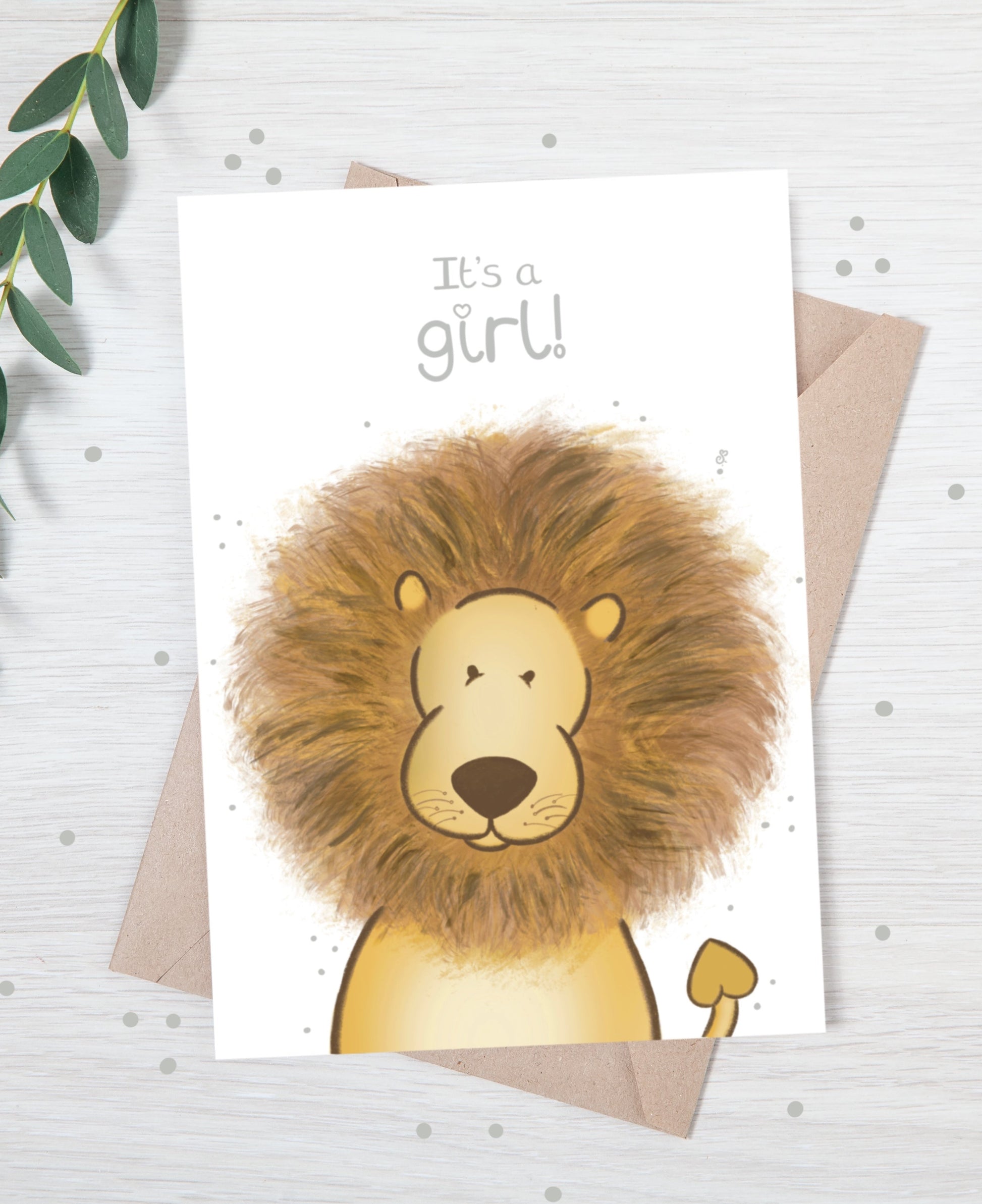 Handmade luxury new baby christening greetings card with a safari theme baby lion popping up from the bottom with the title &quote "it's a girl" on a white background, with a kraft envelope