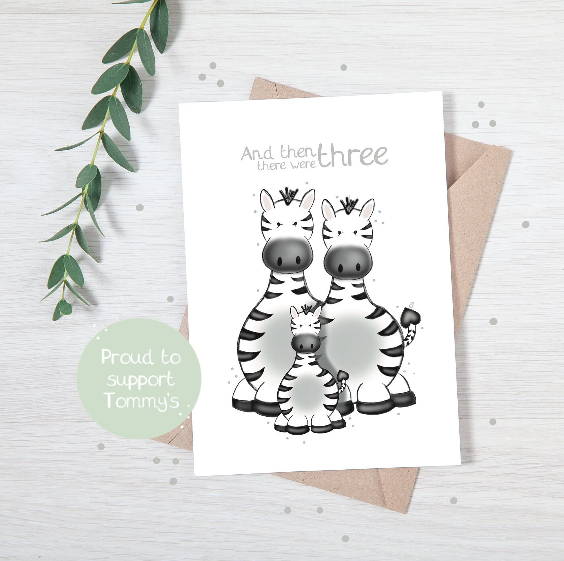 Handmade luxury new baby shower greetings card with a safari theme family of zebras with the title &quote "and then there were three" on a white background, with a kraft envelope